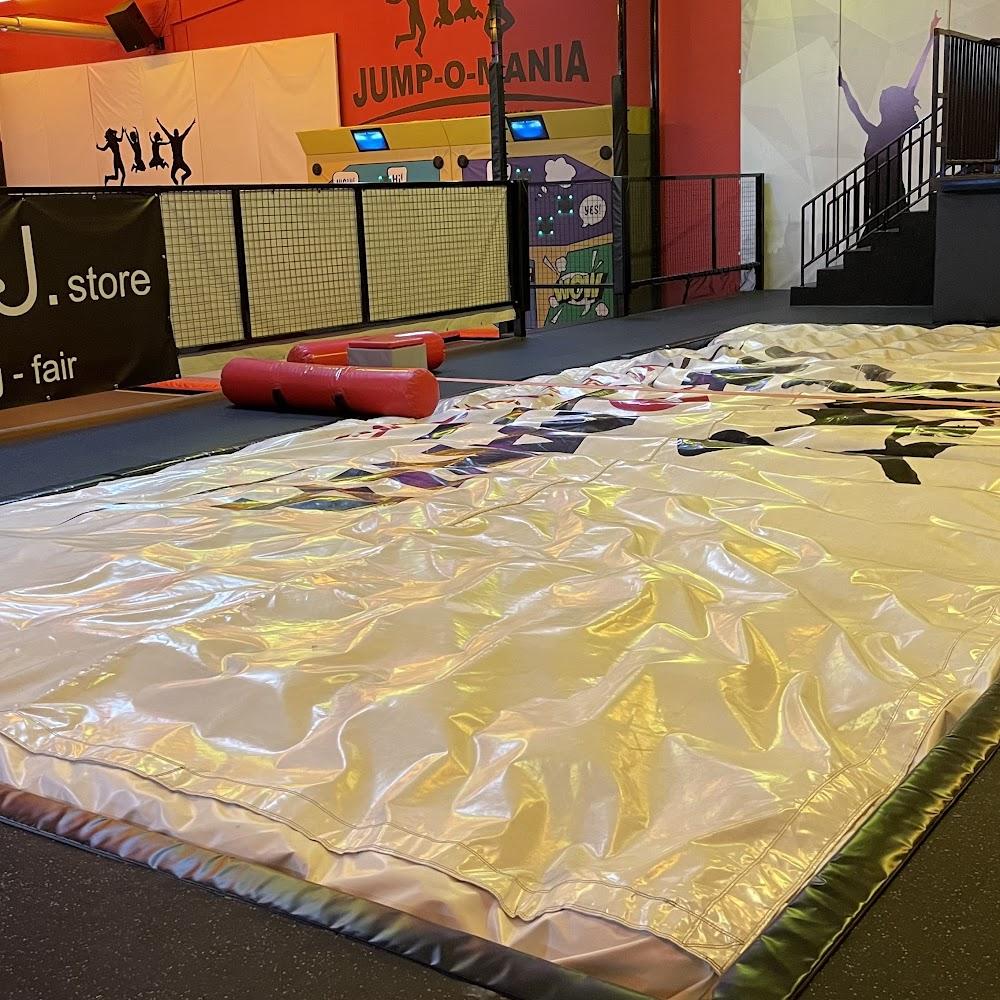 A white, air-filled landing pad in a Jump-O-Mania trampoline park.